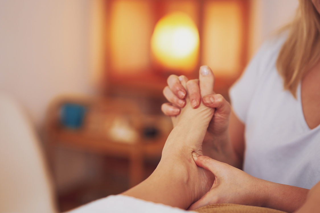 Woman Having Foot Reflexology Massage in Salon